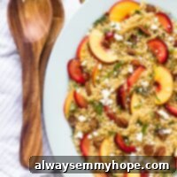 Top-down shot of white plate with quinoa stone fruit salad.