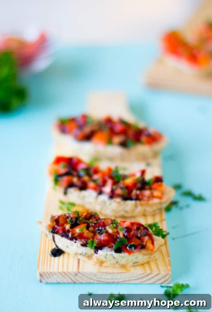 Blog Anniversary Special: 10 Minute Avocado Caprese Bruschetta 7 A row of bruschetta with balsamic glaze on a wood board.