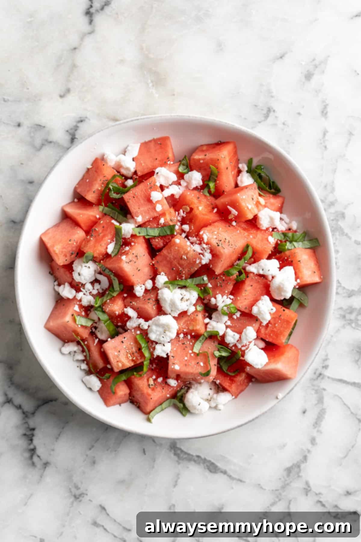 Overhead view of vegan watermelon feta salad before adding balsamic reduction