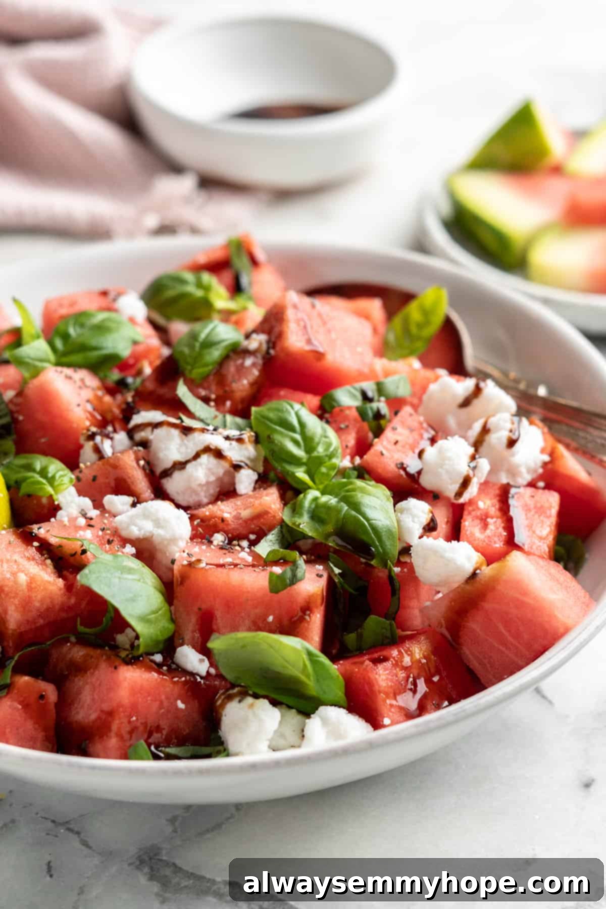 Vegan watermelon feta salad in bowl with spoon