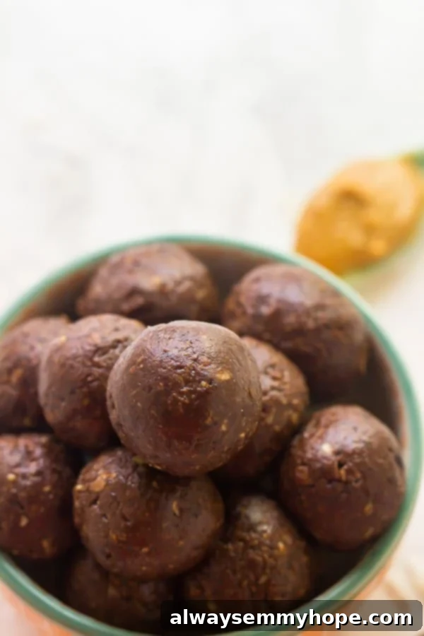 A fresh batch of easy 5-ingredient vegan peanut butter energy balls neatly arranged in a rustic bowl.