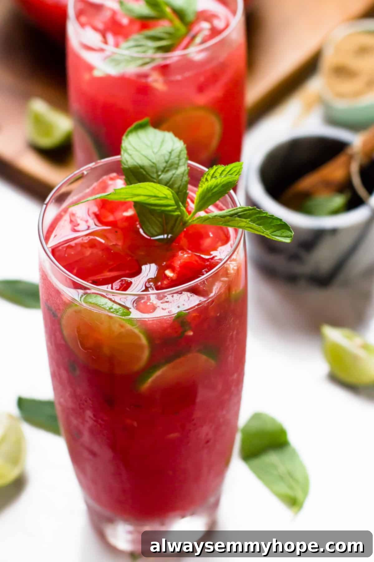 Two tall glasses of watermelon drink. 