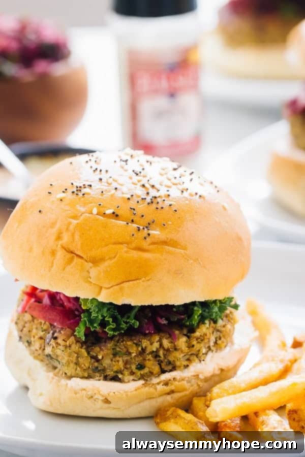 Side shot of a vegan quinoa cauliflower burger with fries on the side. 