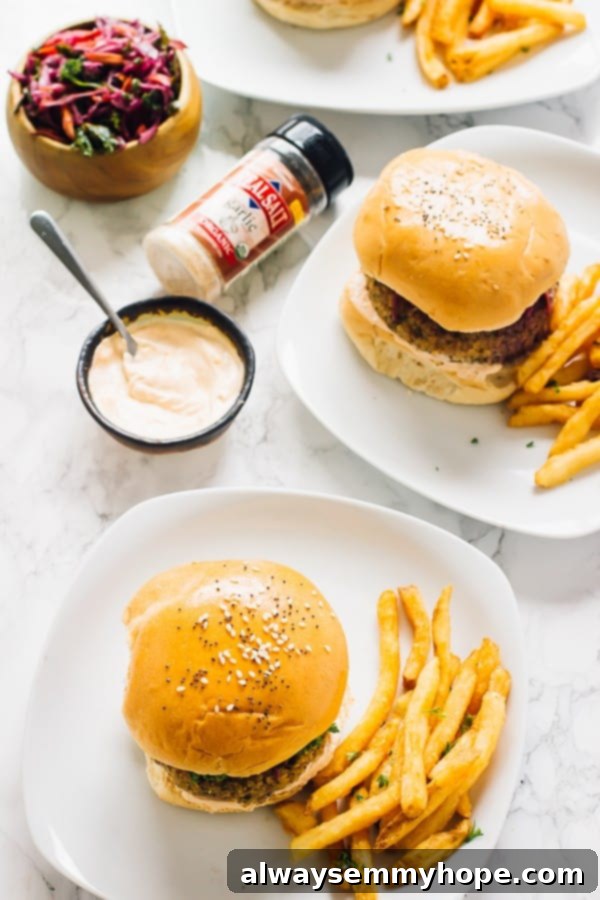 Top down shot of two vegan quinoa cauliflower burgers on a white plates. 