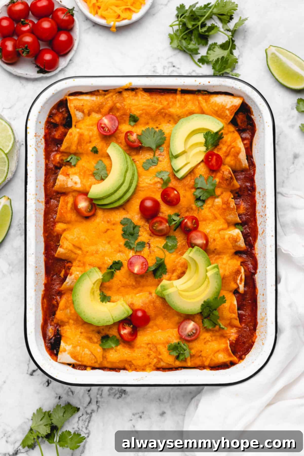 Baked vegan enchiladas with avocado and tomatoes.