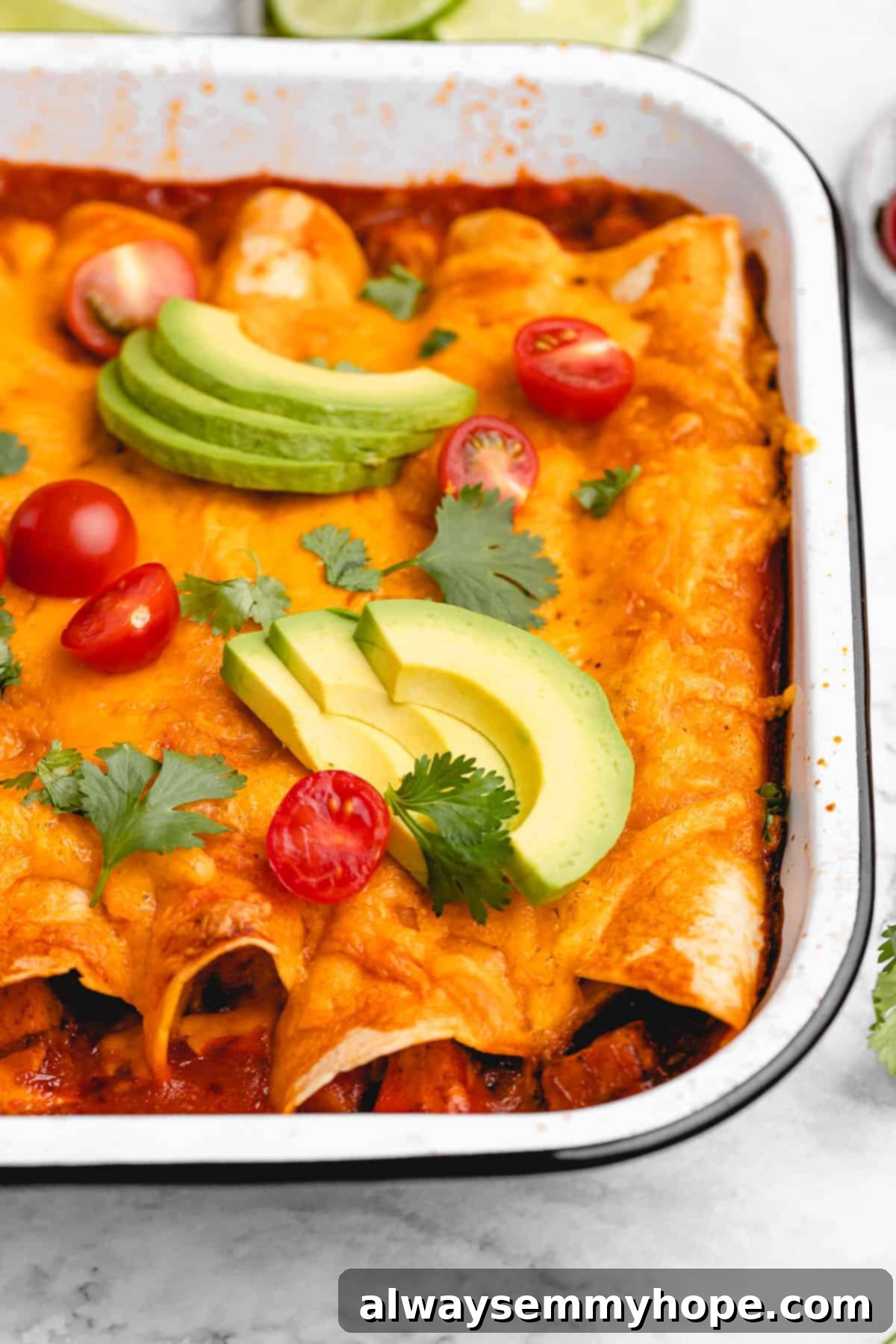 Veggie enchilada covered with avocado and tomato.