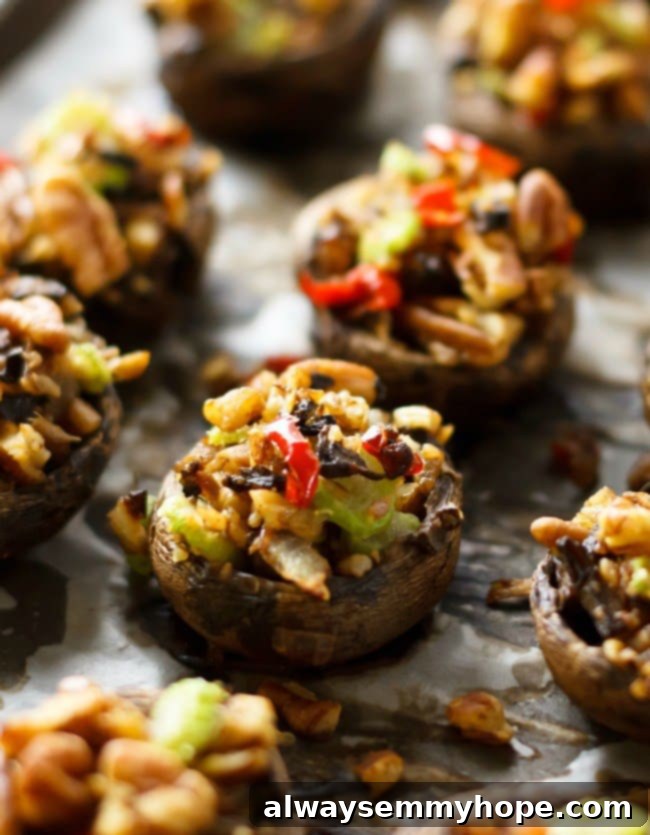 Quick Fall Vegan Dinners: 25 Recipes Ready in 15 Minutes 10 Close up of perfectly baked vegan stuffed portobello mushrooms on parchment paper.