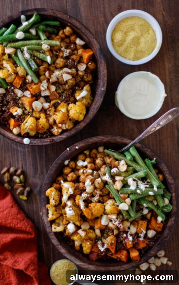 Quick Fall Vegan Dinners: 25 Recipes Ready in 15 Minutes 13 Overhead shot of vibrant roasted cauliflower, sweet potato, chickpea, and green bean red quinoa buddha bowls on a wooden table.