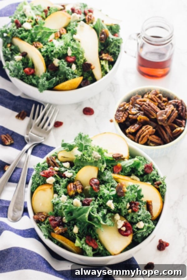 With candied pecans and a tangy apple cider vinaigrette, this easy pear and gorgonzola salad has the perfect balance of flavours! Two vibrant bowls of pear and gorgonzola salad, ready to be served.