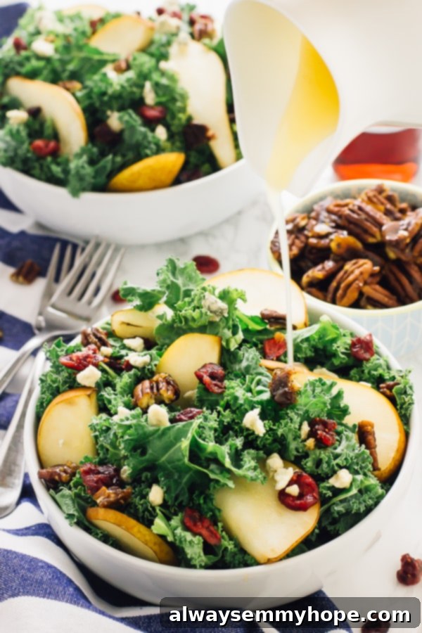 With candied pecans and a tangy apple cider vinaigrette, this easy pear and gorgonzola salad has the perfect balance of flavours! Pouring apple cider vinaigrette dressing onto a beautifully arranged pear and gorgonzola salad.