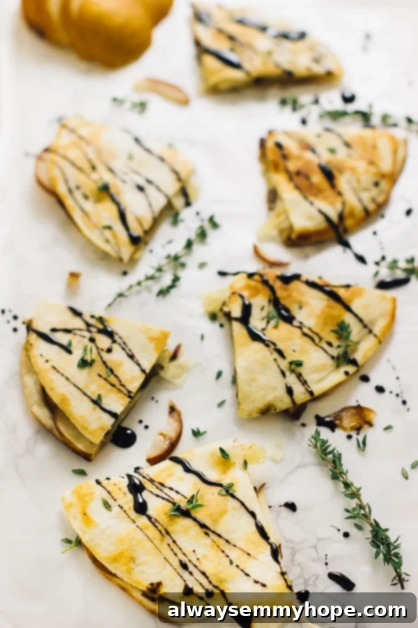 Overhead shot of freshly cooked quesadillas, cut into wedges and generously drizzled with a glossy balsamic glaze, garnished with fresh thyme sprigs.