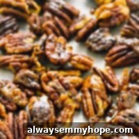 Top down shot of candied pecans on a baking tray.