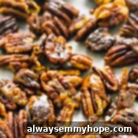 Top down shot of candied pecans on a baking tray.