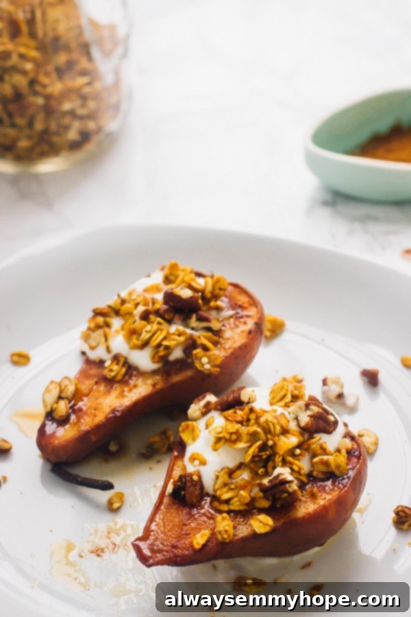 Two baked cinnamon pears with a generous crunch topping, highlighting the rich texture and delicious appeal of the dessert.