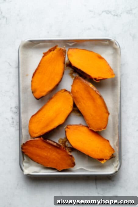 Stuffed Sweet Potato Skins 6 Overhead view of halved sweet potatoes on baking sheet