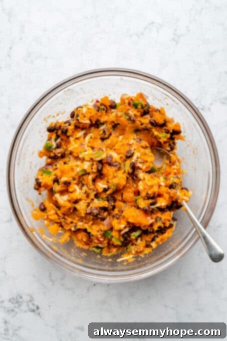 Stuffed Sweet Potato Skins 9 Overhead view of sweet potato skin filling in glass bowl with spoon