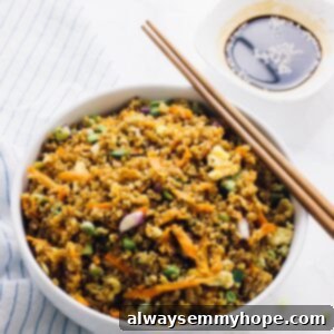 Speedy 15 Minute Quinoa Fried Rice 8 Quinoa fried rice in a white bowl with chopsticks on the side.