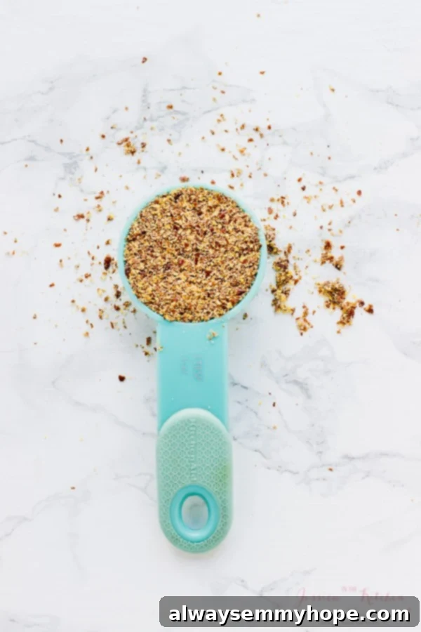 Overhead shot of flax seeds in a blue spoon.