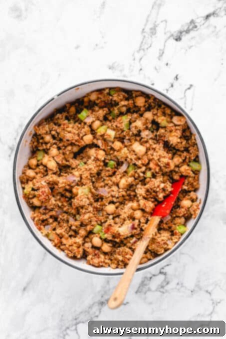 This vegan meatloaf makes a perfect Thanksgiving main dish or entree! It's moist and full of flavor, with just 15 minutes of prep. Dig in! Vegan meatloaf mixture in a large mixing bowl with a spatula.