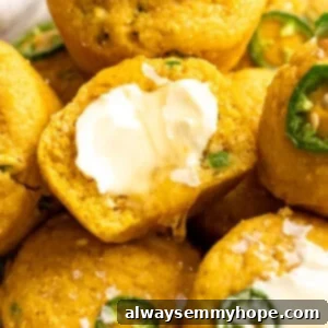 Zesty Vegan Jalapeño Cornbread Muffins 2 Vegan cornbread muffins topped with butter and flaky salt.
