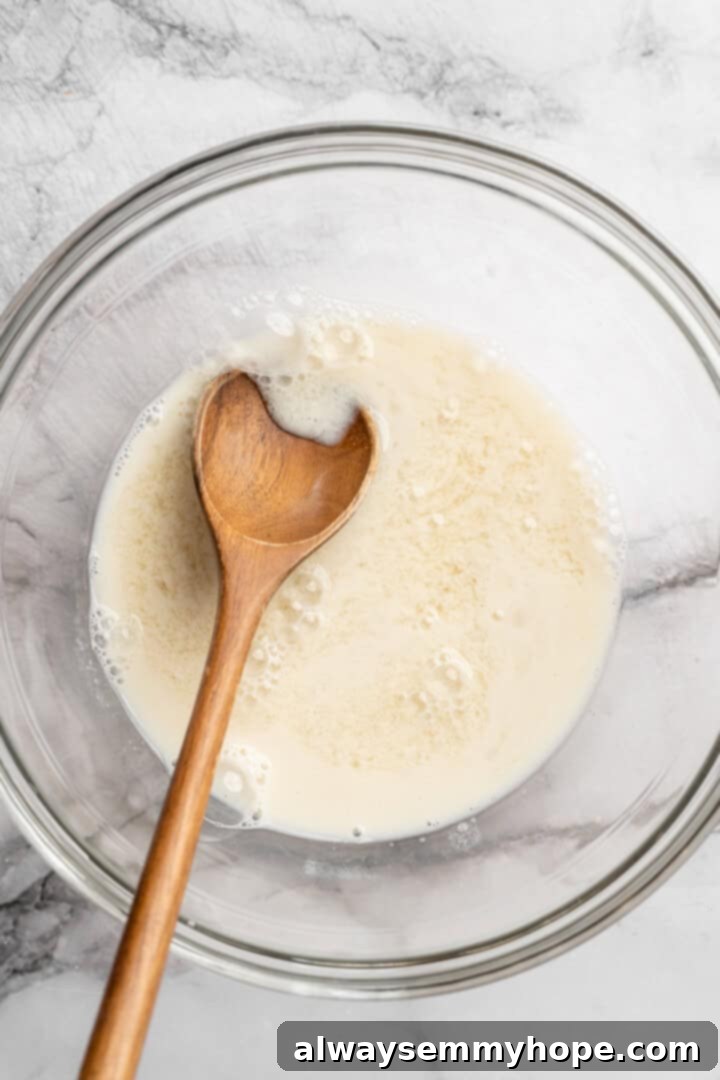 These moist vegan jalapeño cornbread muffins are easy to make and have a gluten-free option, which means everyone can enjoy them! Vegan buttermilk in bowl with wooden spoon.
