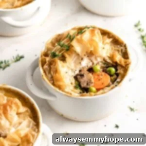 Hearty Vegan Pot Pies 2 Vegan pot pies in white ramekins, center pie with filling visible
