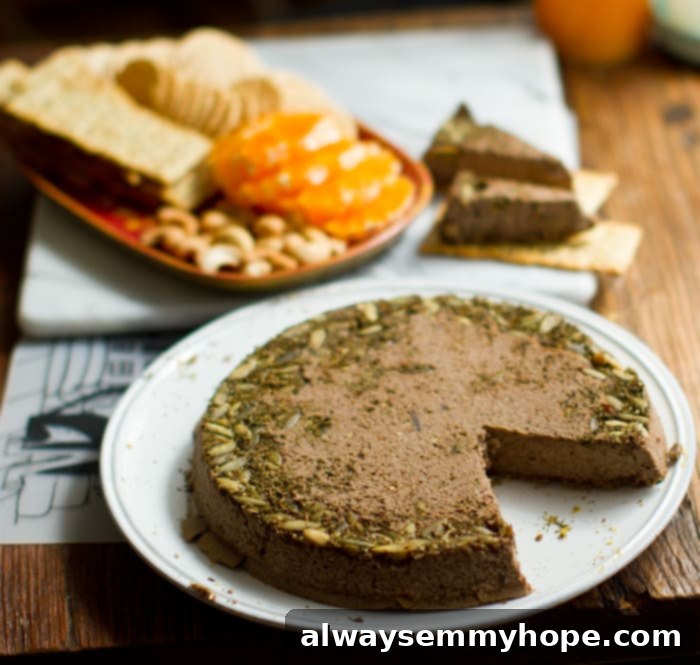 Lentil loaf with a slice taken out on a white plate. 