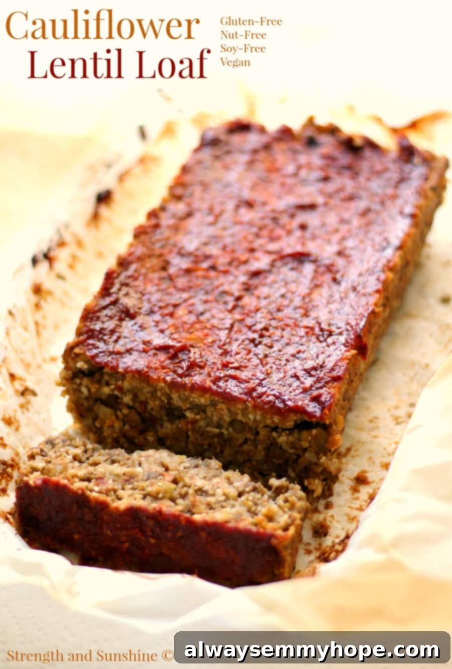 Cauliflower lentil loaf with a slice cut off.