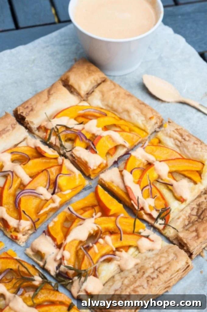 Slices of savory pumpkin tart on a blue cloth with a spoon on the side. 