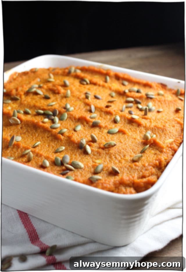 Pumpkin lentil shepherds pie in a white baking dish.
