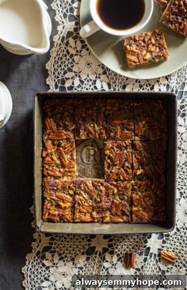 Overhead shot of paleo pecan pie in a square baking pan with coffee on the side.