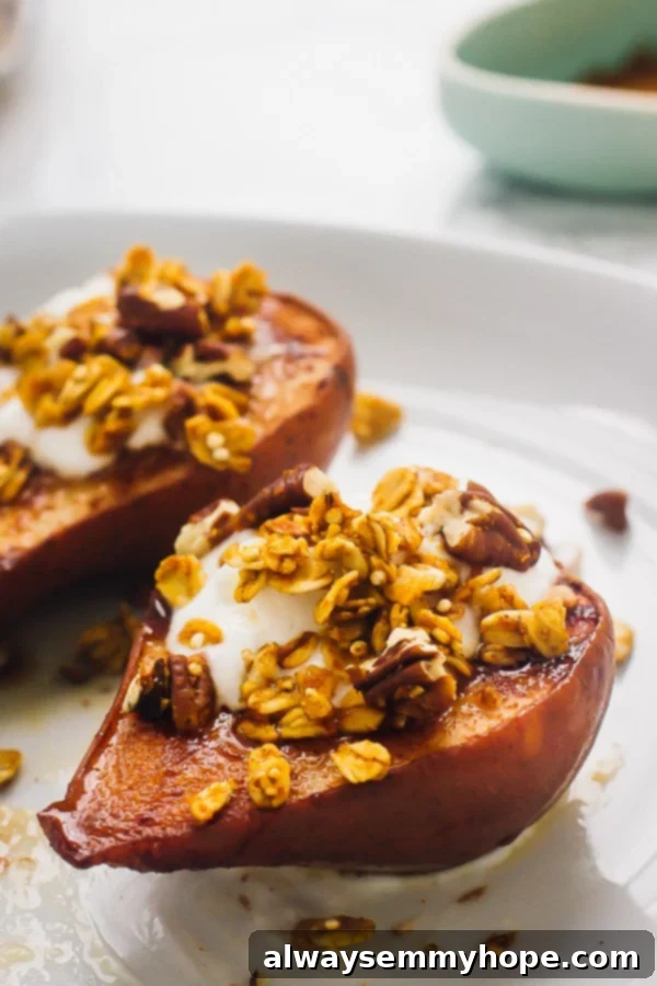 Two vegan cinnamon baked pears with crunchy topping on a white plate.
