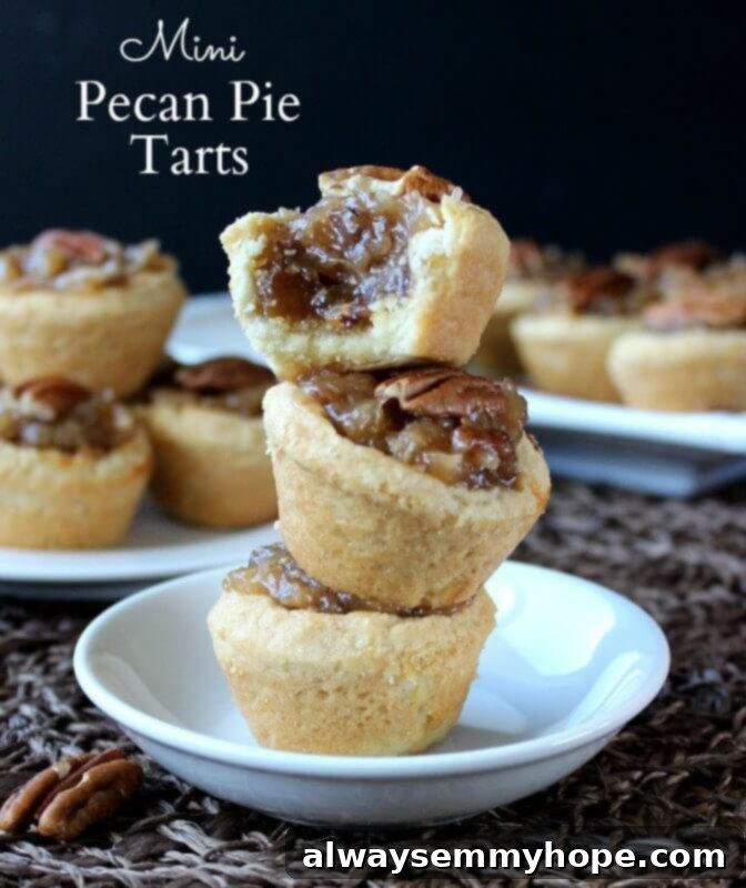 A stack of mini pecan pie tarts on a white dish. 