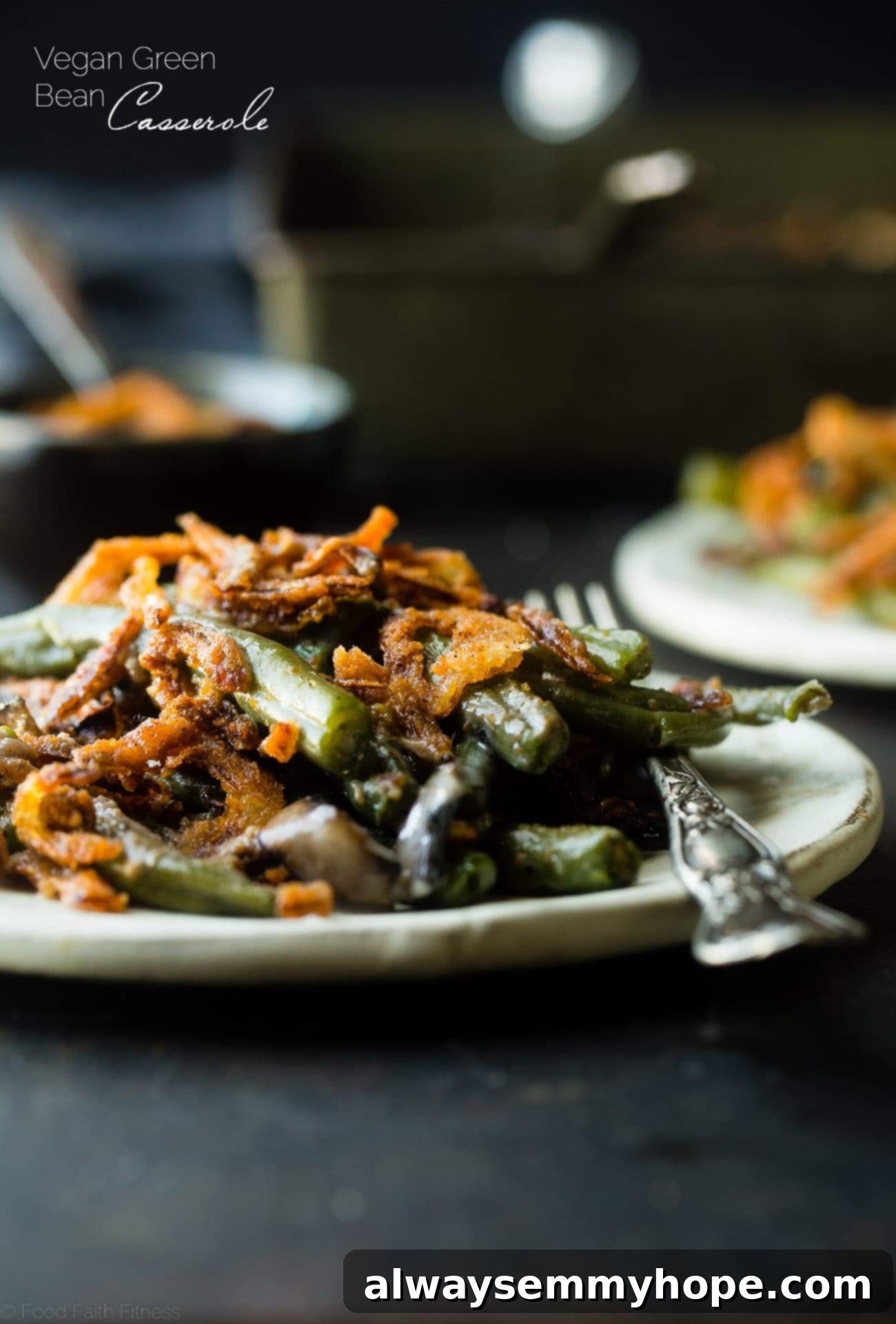 Side on shot of vegan green bean casserole on a plate with a fork on the side. 