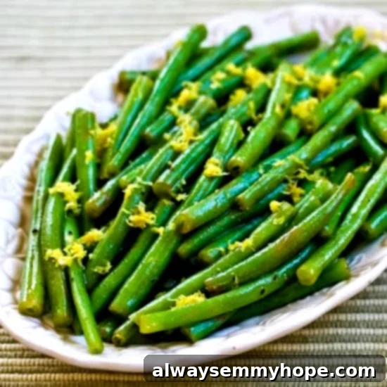 Lemony green beans on a long white dish.