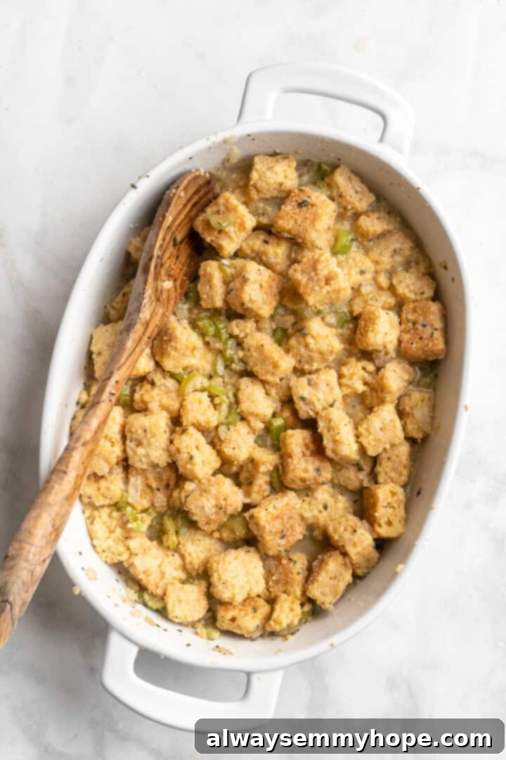 Overhead view of the assembled cornbread stuffing in a baking dish, perfectly moist and seasoned, ready to be placed in the oven