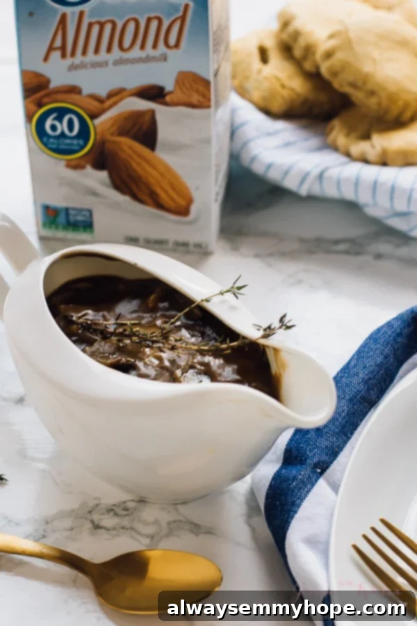 A pristine gravy boat overflowing with homemade vegan mushroom gravy, with a carton of almond milk softly blurred in the background.