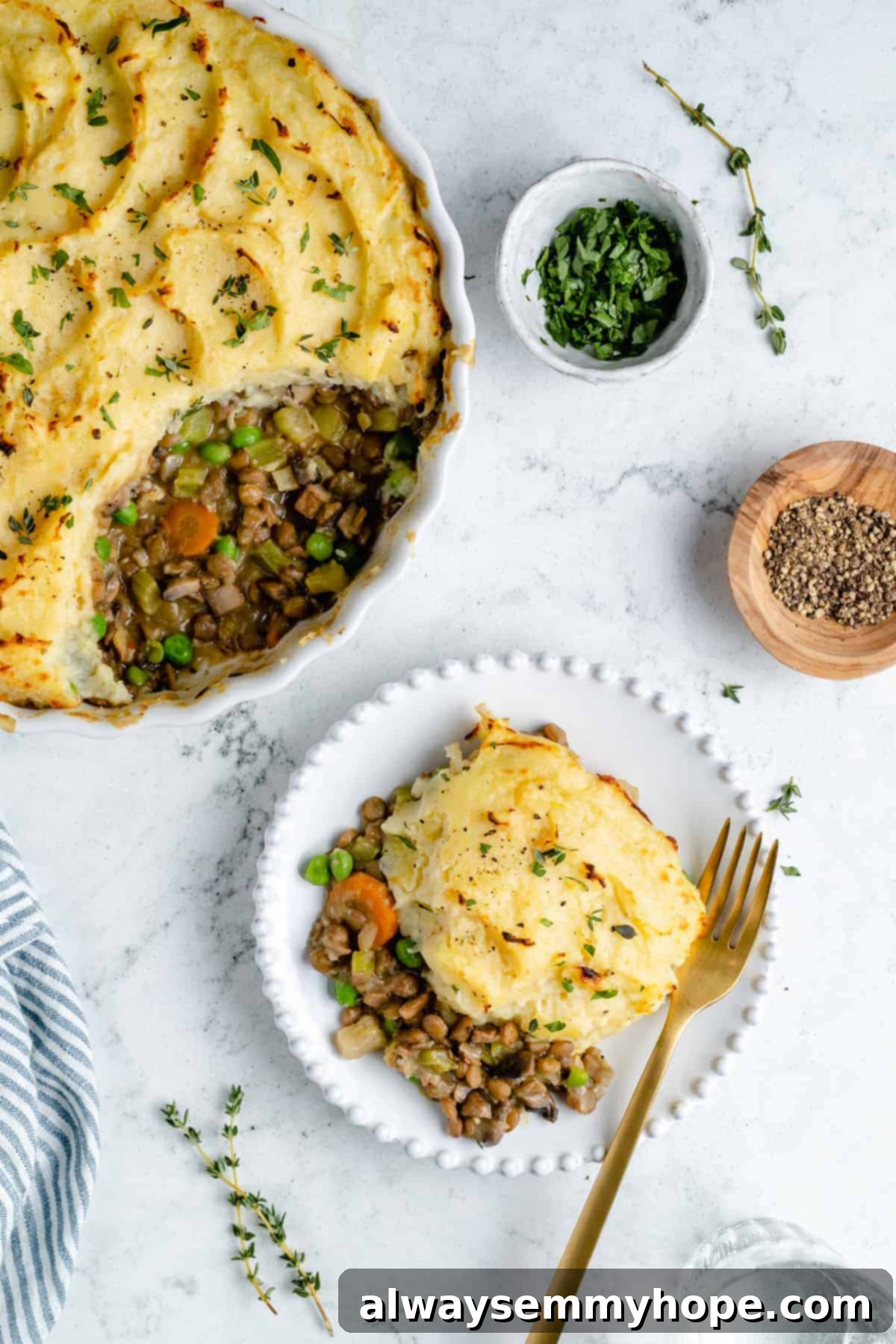 Hearty Vegan Shepherd's Pie 14 Plated serving of Vegan Shepherd's Pie with a fork, showcasing the fluffy mashed potato topping and rich, savory filling
