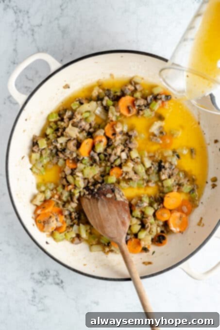 Hearty Vegan Shepherd's Pie 7 Pouring vegetable broth into the flour-coated vegetable mixture in a Dutch oven for the Vegan Shepherd's Pie
