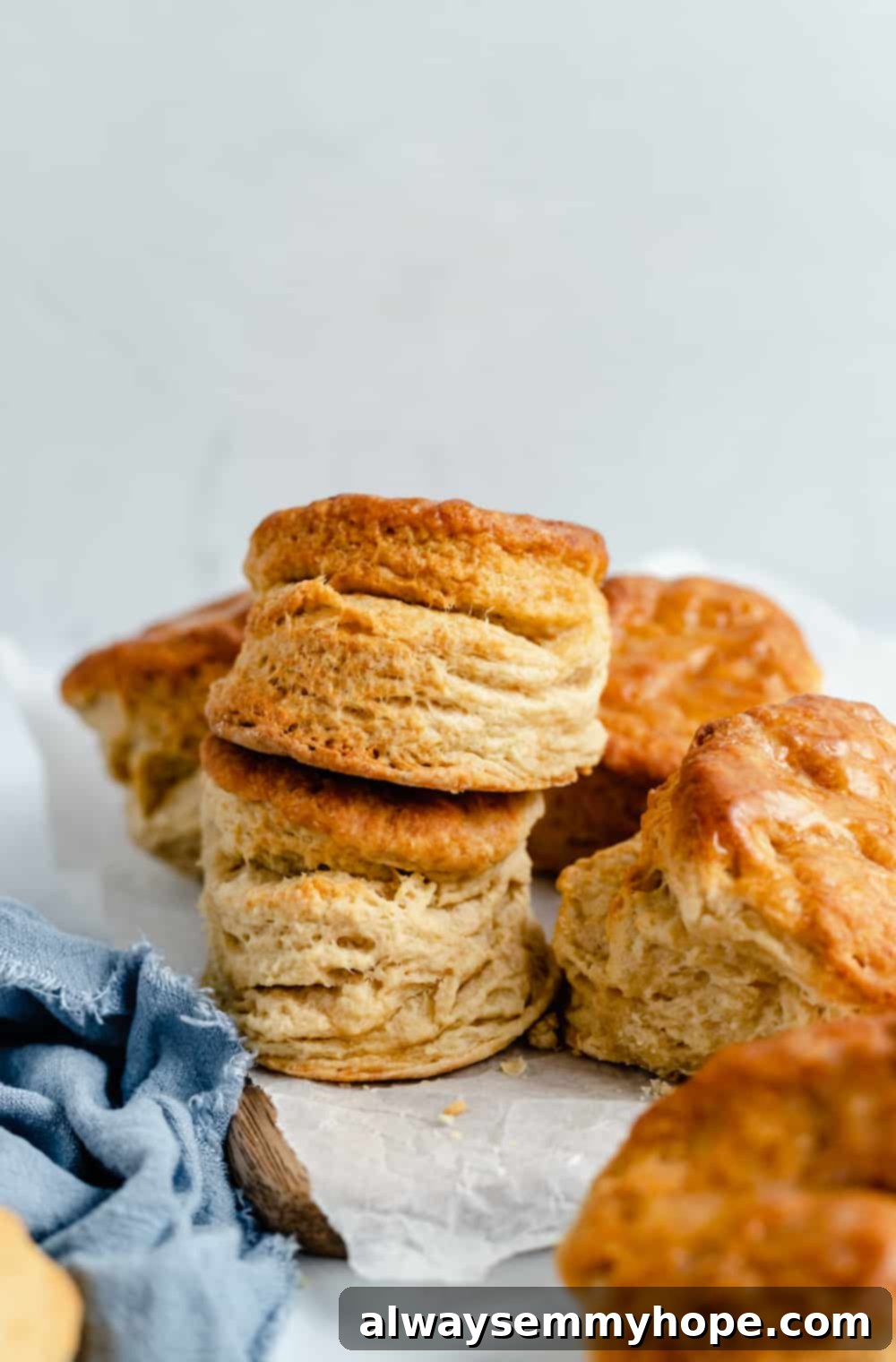 A charming pile of freshly-baked vegan biscuits artfully arranged on a piece of wax paper, awaiting eager hands.