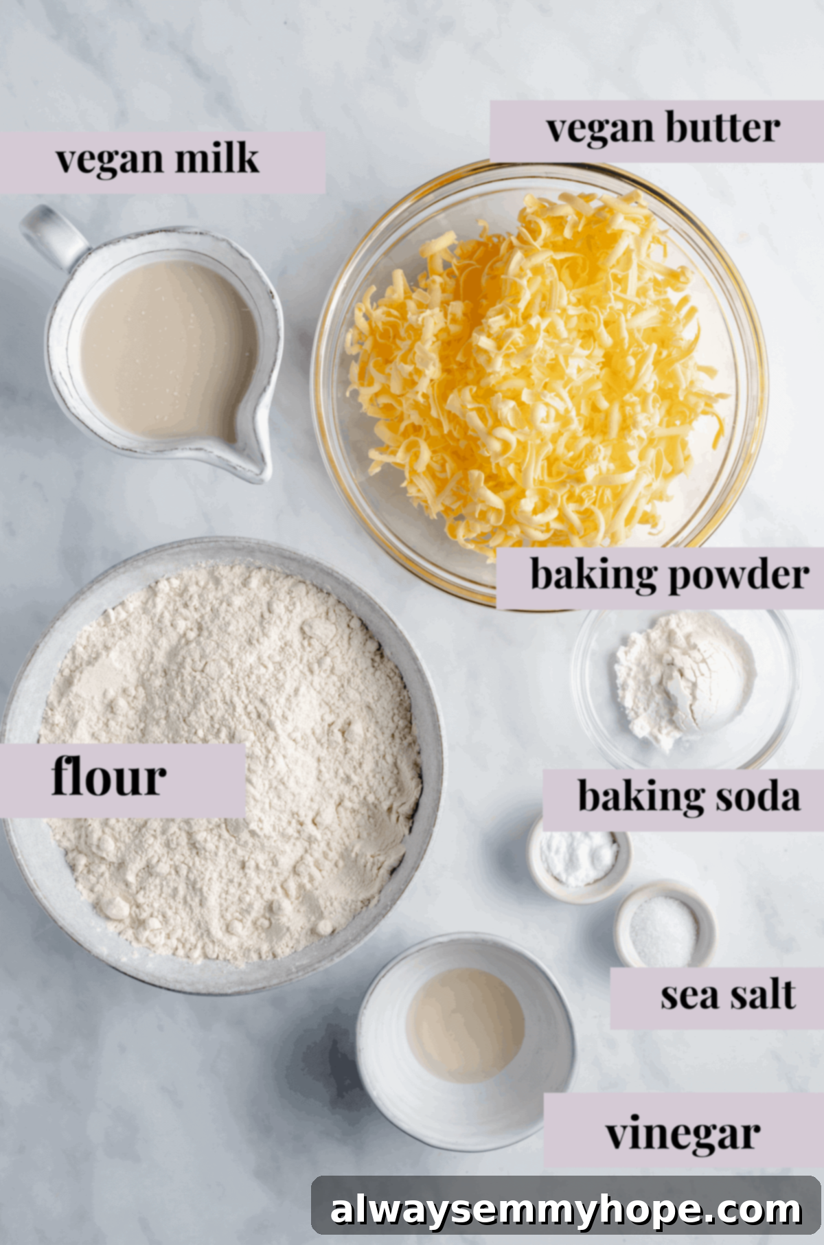 A beautiful flat lay of the 7 essential ingredients for making vegan biscuits, neatly arranged on a counter.