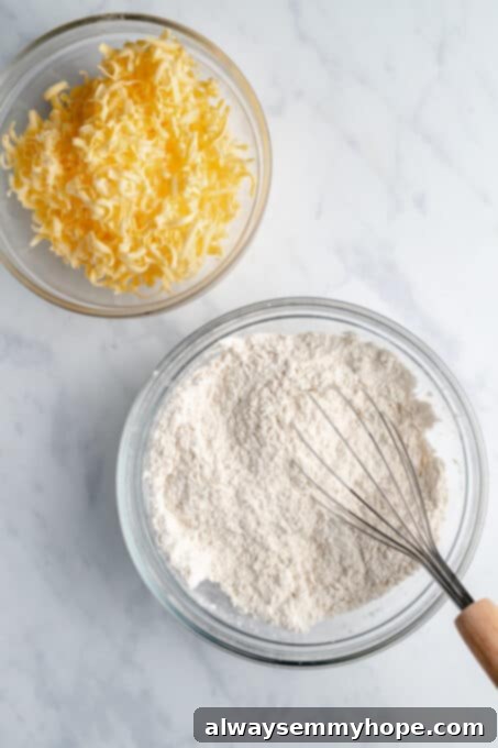 Two clear bowls, one with flour and the other with chunks of cold vegan butter, ready for mixing.