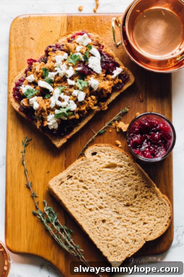 Thanksgiving's Vegetarian Encore: Meatloaf & Cranberry Sandwich 3 Top down shot of open vegetarian sandwich on wood board.
