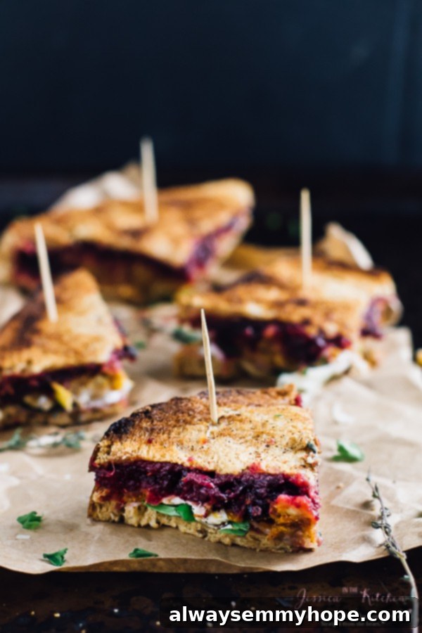 Thanksgiving's Vegetarian Encore: Meatloaf & Cranberry Sandwich 4 Three slices of vegetarian meatloaf sandwich on parchment paper.