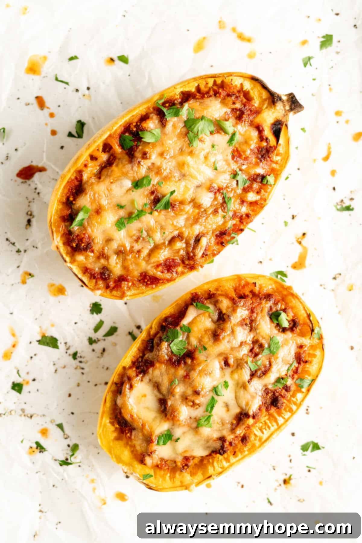 Overhead view of two spaghetti squash halves stuffed with lasagna