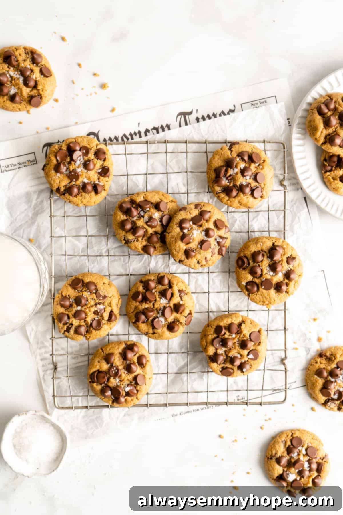 These vegan gluten-free chocolate chip cookies are an easy one-bowl recipe! Make soft, chewy, bakery-style cookies loaded with chocolate. Overhead view of assorted vegan gluten-free chocolate chip cookies in a wire rack.