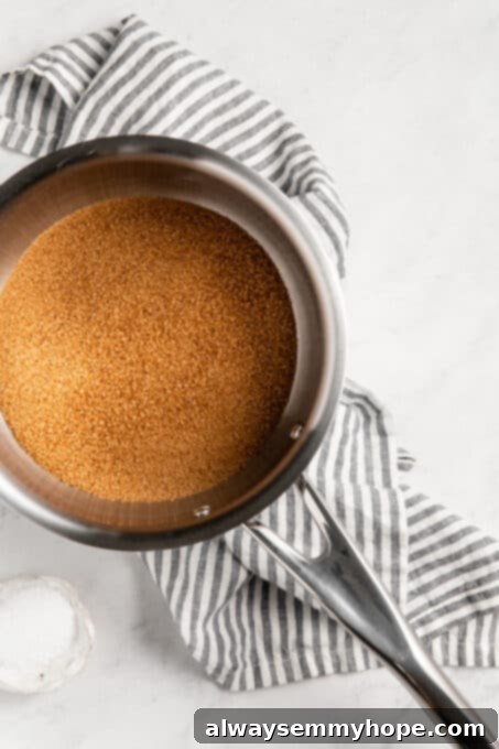 Simple Plant-Based Caramel 4 Brown sugar in a saucepan, being stirred.