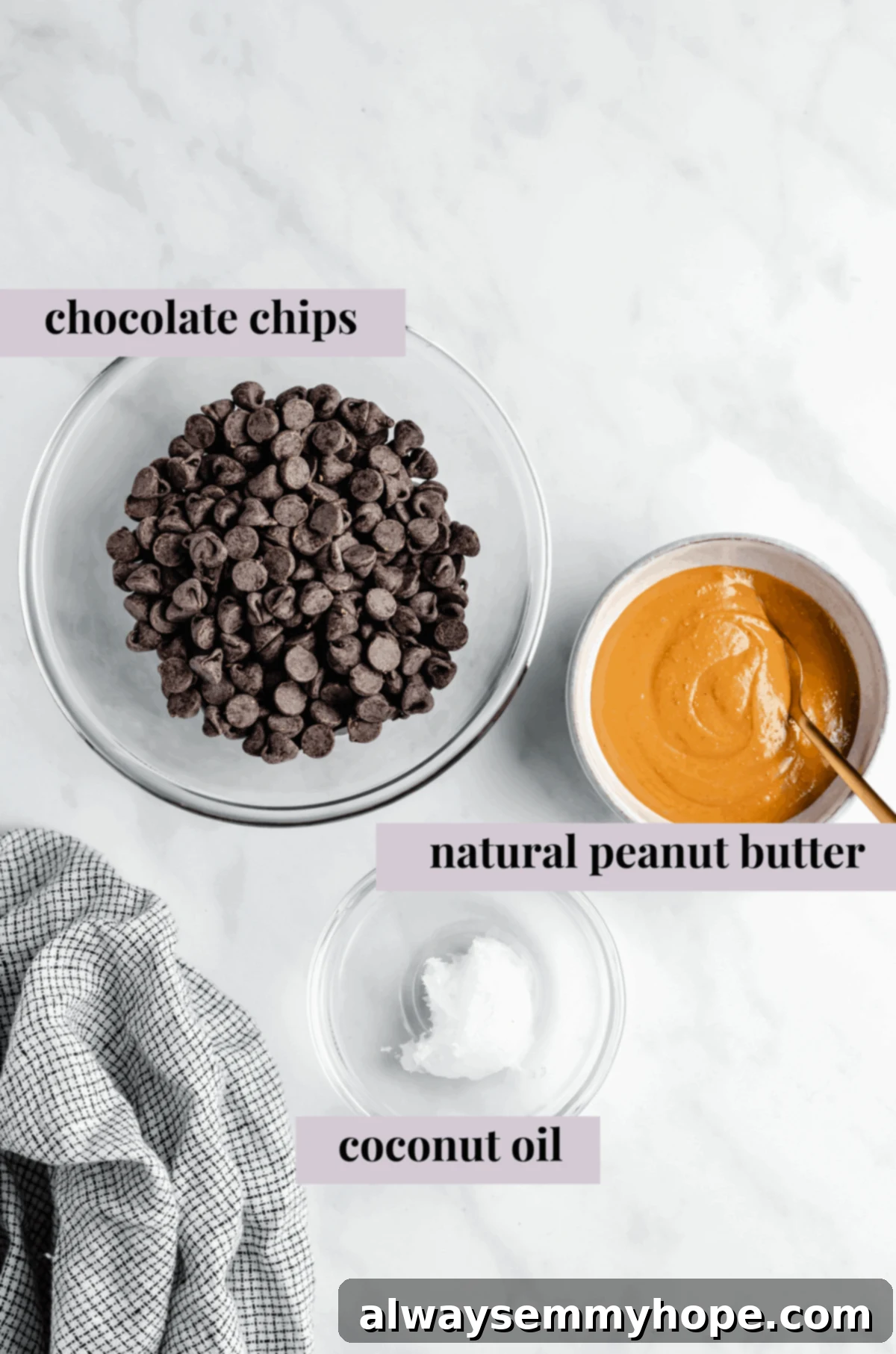 Overhead shot of glass bowls containing chocolate chips, natural peanut butter, and a jar of coconut oil, the three main ingredients for vegan peanut butter cups.