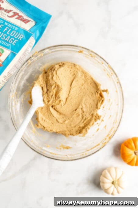 These easy vegan pumpkin cookies are ultra-soft. Made with 10 ingredients, they're topped with an irresistible cream cheese frosting, too! Close-up of vegan butter and brown sugar perfectly creamed together in a mixing bowl, showing a light and fluffy texture.