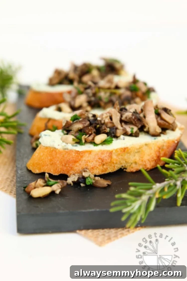 Vegan Christmas Delights: 50 Festive Plant-Based Meals 9 Side on shot of three mushroom crostinis on a black slate.